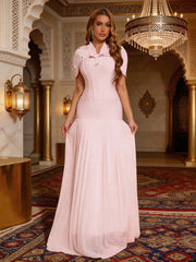 Model wearing a pink pleated hem maxi dress with shawl sleeves