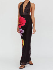 Black halter neck dress with floral design on a white background