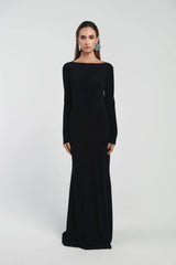 Woman wearing a black long-sleeve gown on a white background