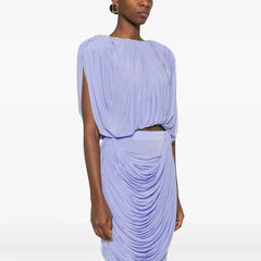 Woman wearing a light purple dress with a draped design on a white background