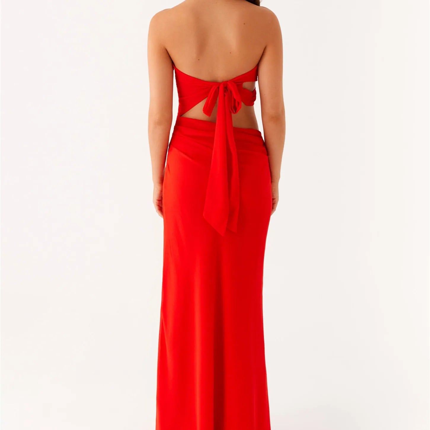 Red strapless gown with cut-out back on a white background