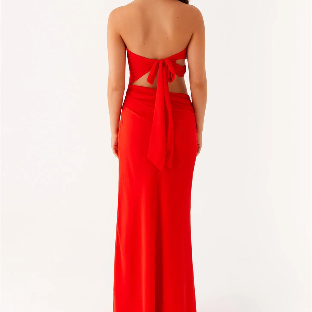 Red strapless gown with cut-out back on a white background