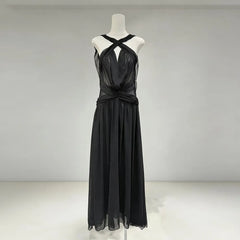 Black evening gown on a mannequin against a plain background