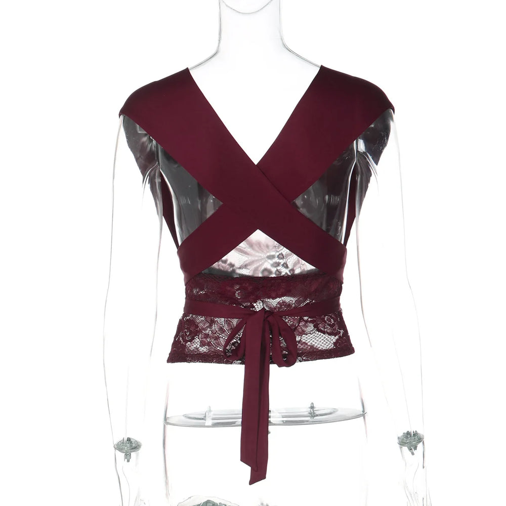 Maroon top with lace detailing on a mannequin against a white background