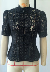 Black lace top on a mannequin with a white background
