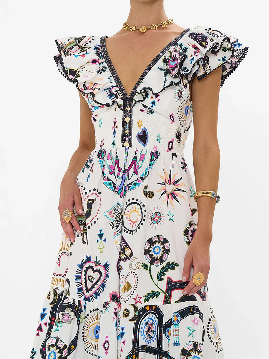 Woman wearing a colorful patterned dress with a white background