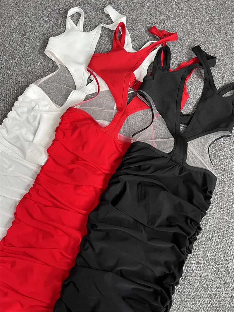 Three strappy tops in white, red, and black on a gray surface