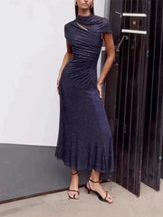 Dark blue sequin midi dress with a high neckline and cut-out detail, worn by a model.