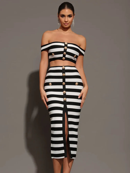 Woman wearing a black and white striped outfit with button details on a gray background