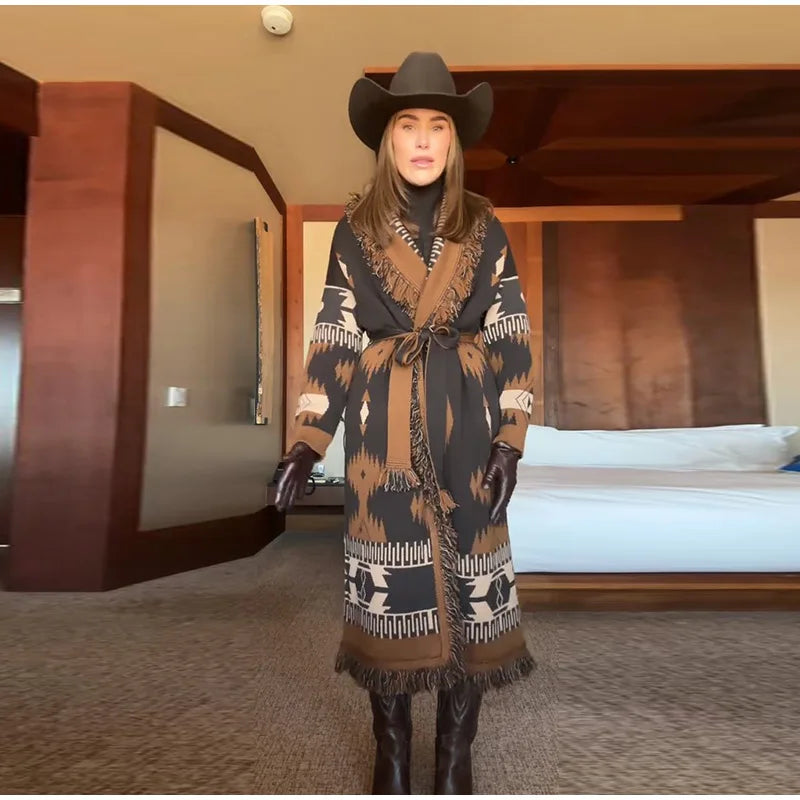 Person wearing a patterned coat and cowboy hat in a bedroom setting