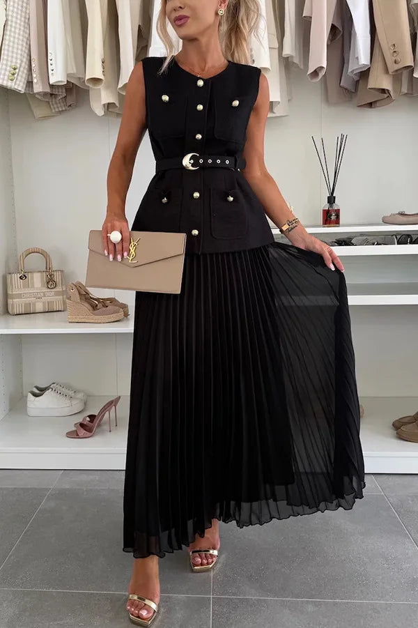 Woman wearing a black dress with gold buttons in a clothing store.