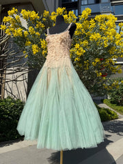 Mannequin wearing a dress with a floral top and light green skirt in front of yellow flowers.