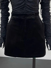 Black textured top and skirt set on a mannequin against a neutral background