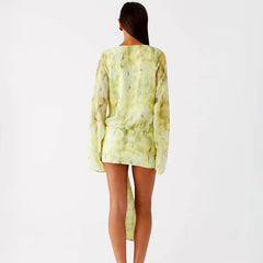 Woman wearing a light green dress with a subtle pattern