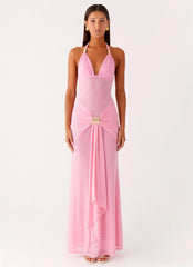 Woman wearing a pink evening gown with a white background
