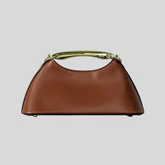 Brown trapezoid top handle bag with a gold metal bar handle