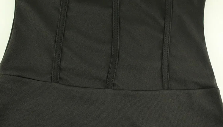 Close-up of a black dress with a plain background