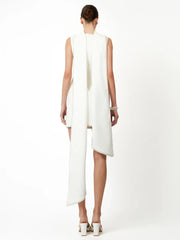 Woman wearing a white sleeveless dress with a slit on a white background