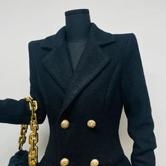 Dark blue coat with gold buttons and a gold chain on a mannequin against a light gray background