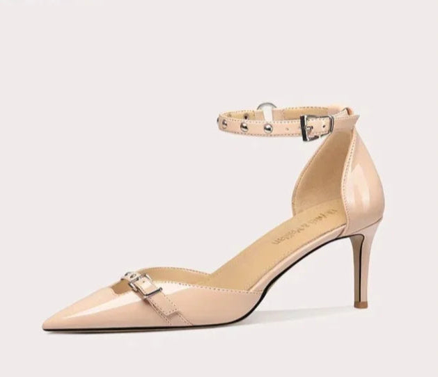 Beige high-heeled shoe with ankle strap on a light gray background