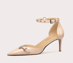 Beige high-heeled shoe with ankle strap on a light gray background