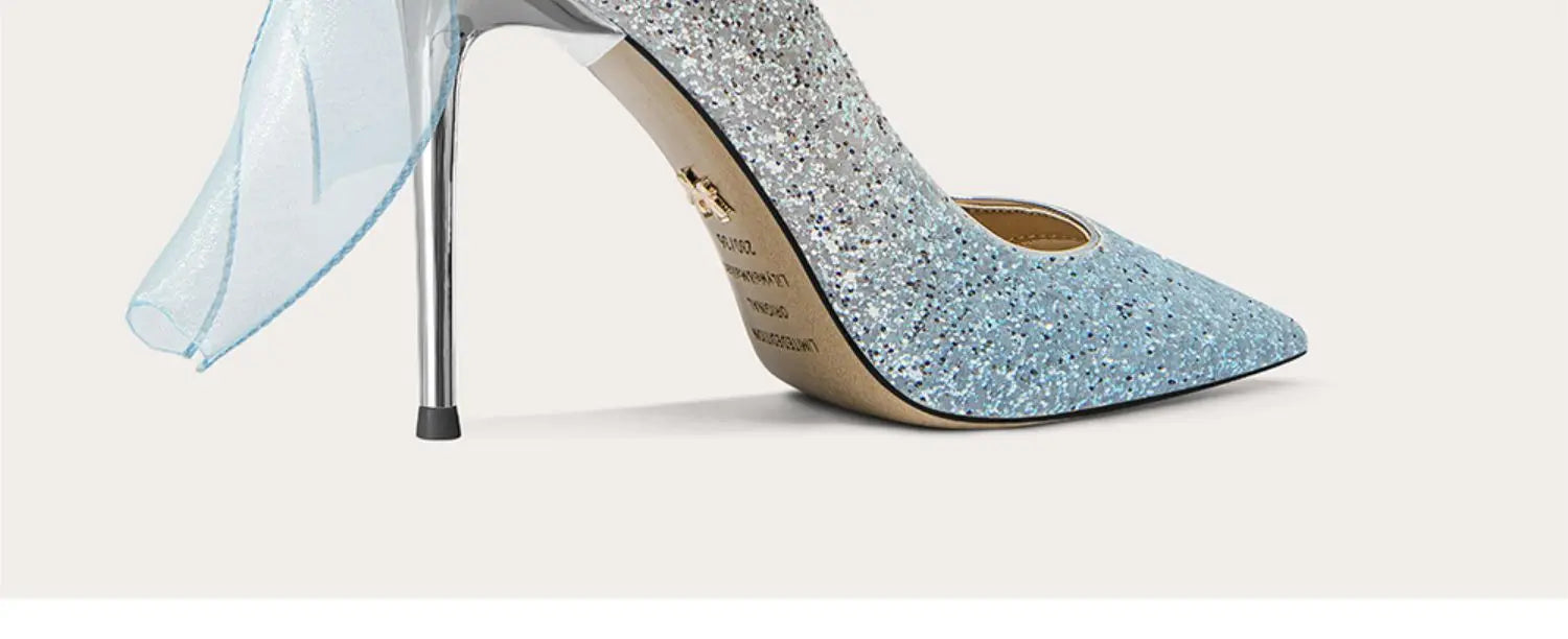 Blue glitter high-heeled shoe on a light gray background