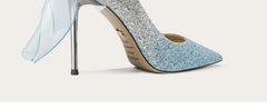 Blue glitter high-heeled shoe on a light gray background