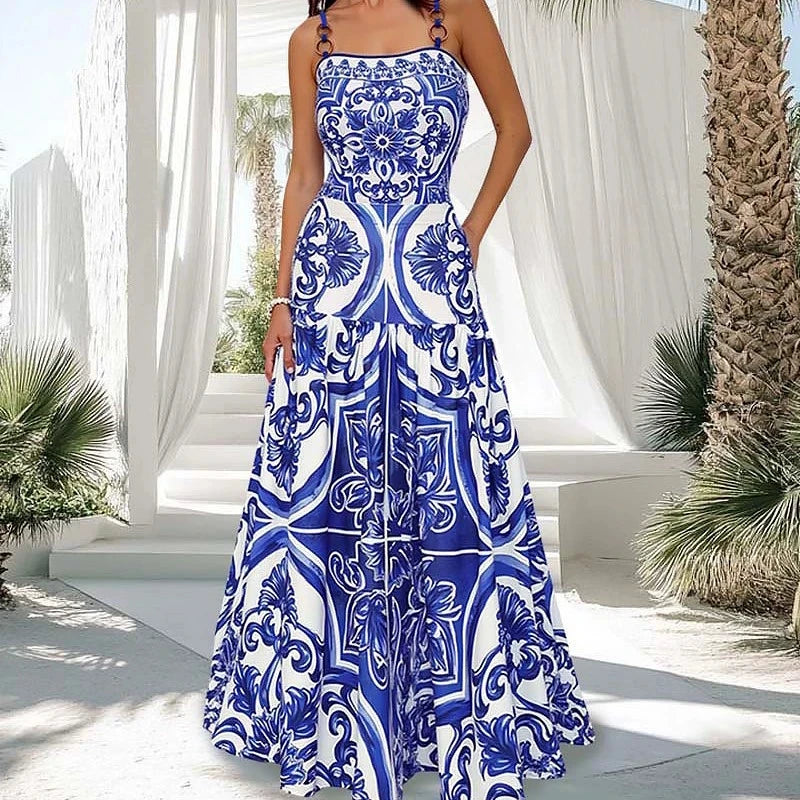 Woman wearing a blue and white tile print maxi dress.