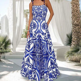 Woman wearing a blue and white tile print maxi dress.