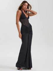 Black halter neck maxi dress with sheer bodice and ruched skirt