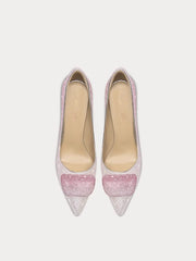 Pair of glittery pink high-heeled shoes on a light gray background