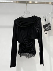 Black long-sleeve top with lace detail on a hanger against a white background