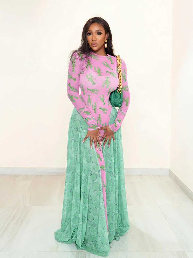 Woman wearing a pink and green dress with a gold clutch against a white background