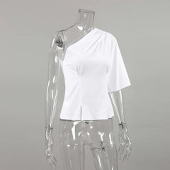 White one-shoulder top on a transparent mannequin against a gray background