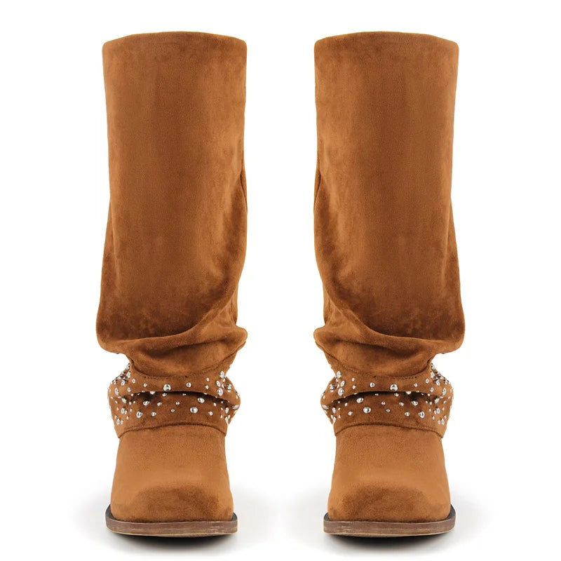 Front view of two brown faux suede boots with studded fold-over cuffs.