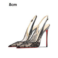 Black lace high-heeled shoes with red soles on a white background
