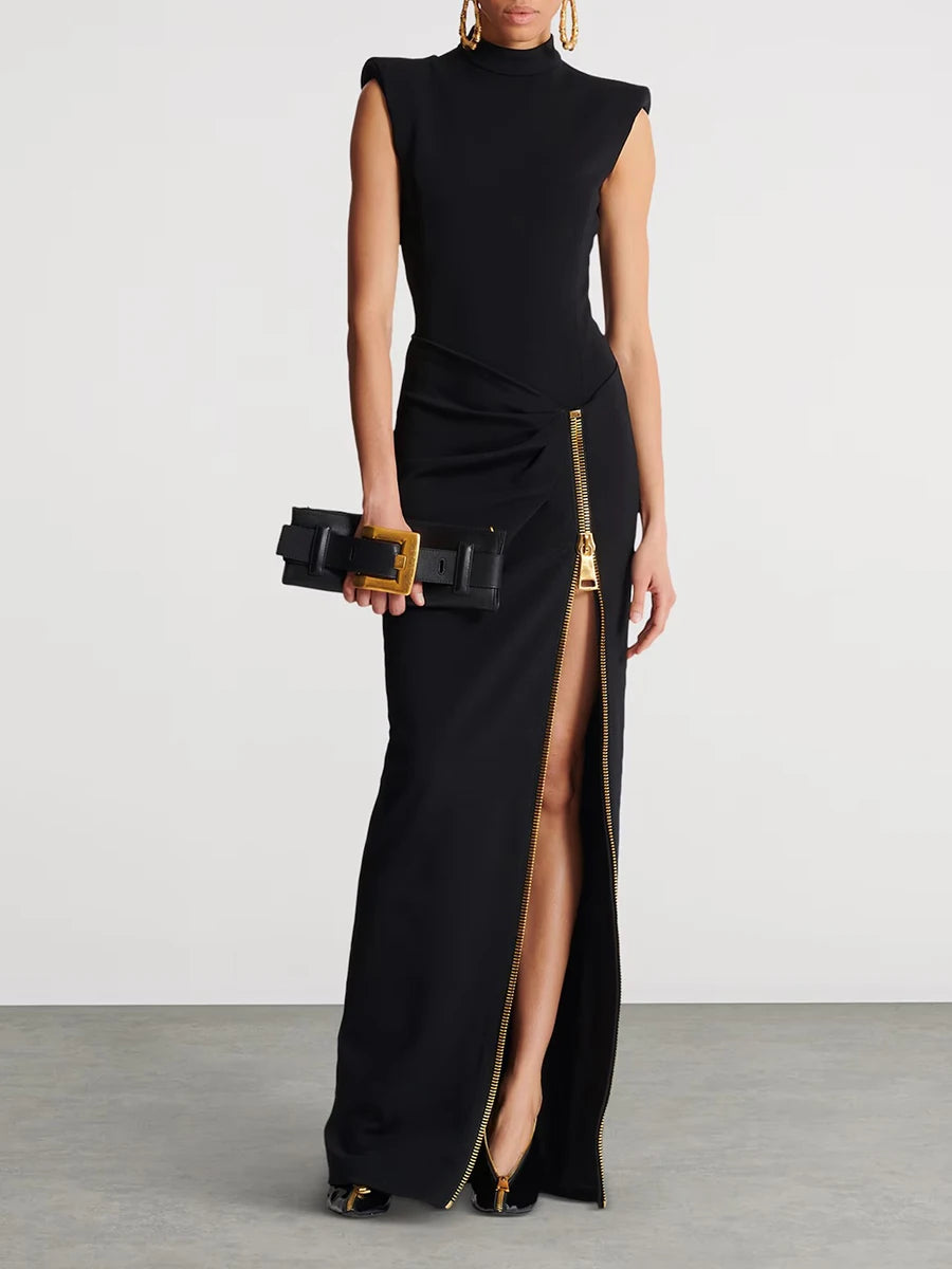 Black evening gown with a high slit and gold belt on a plain background