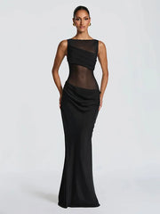 Black evening gown with sheer overlay on a white background