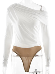 White long-sleeve top with a sheer overlay and beige thong on a mannequin against a white background.