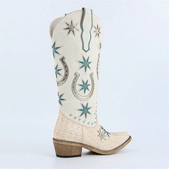 White cowboy boot with star and horseshoe designs on a light blue background