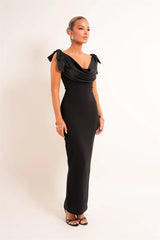 Side view of black draped cowl bow shoulder maxi dress