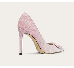 Pink glitter high heel shoe on a light gray background