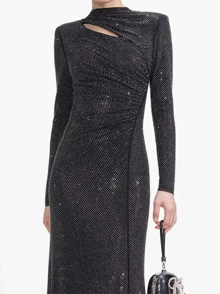 Black sequin dress with long sleeves on a white background