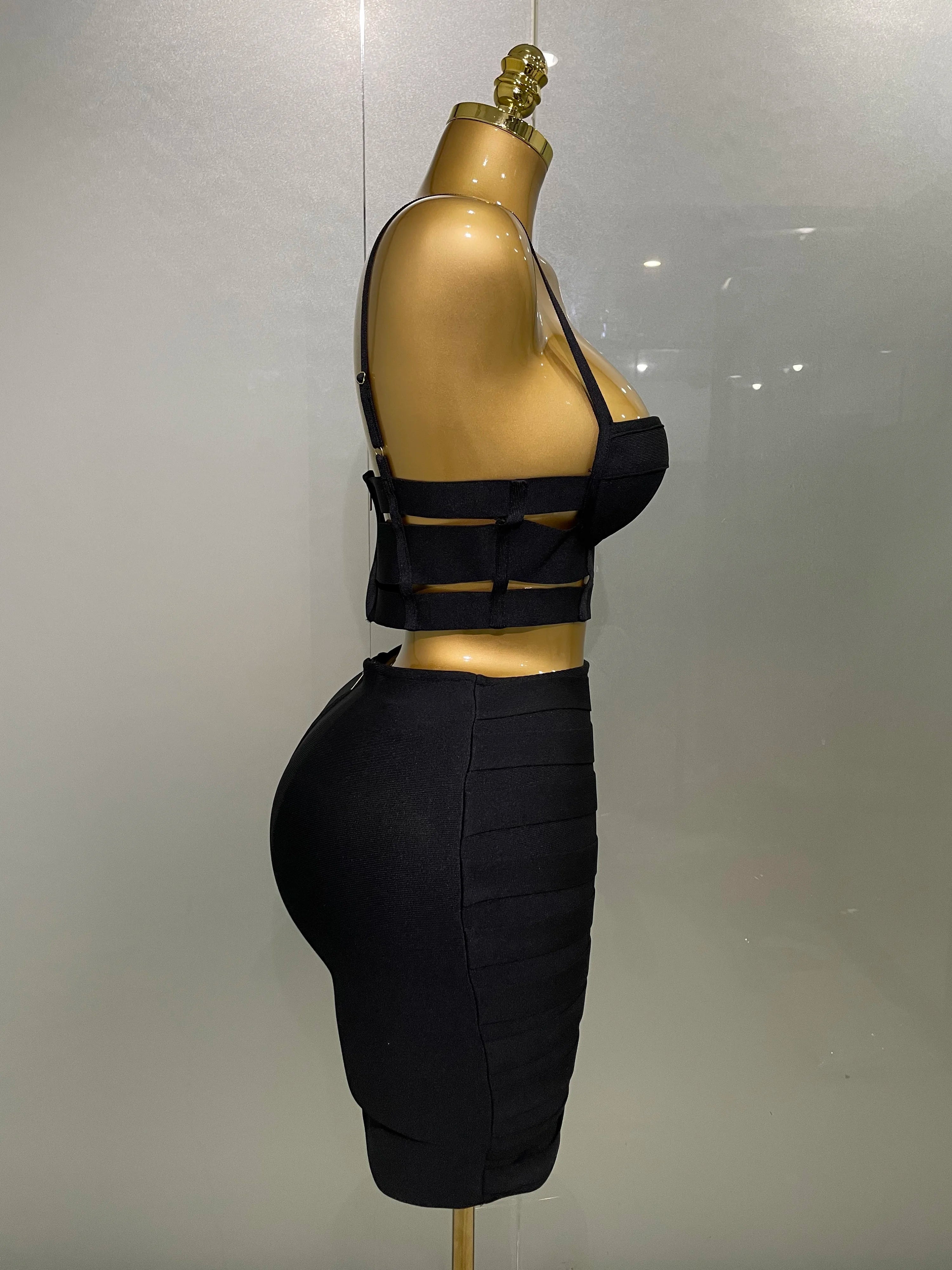 Black outfit on a mannequin against a plain background