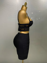 Black outfit on a mannequin against a plain background