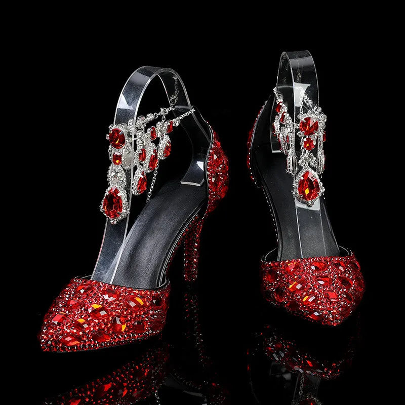 Red high-heeled shoes with gemstones on a black background