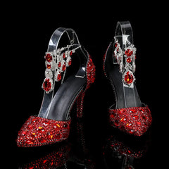 Red high-heeled shoes with gemstones on a black background