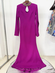 Purple maxi dress with cape sleeves and beaded neckline on display