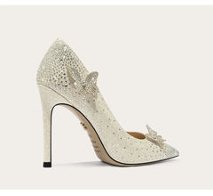 Sparkly high-heeled shoe with decorative bow on a light background