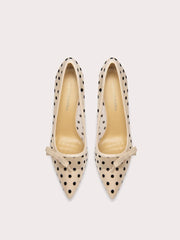 Pair of polka dot high-heeled shoes on a white background